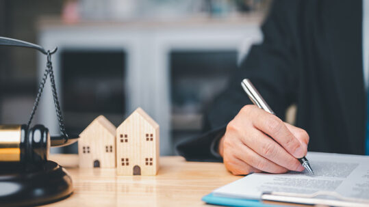 Attorney signing documents symbolizing asset division during a divorce